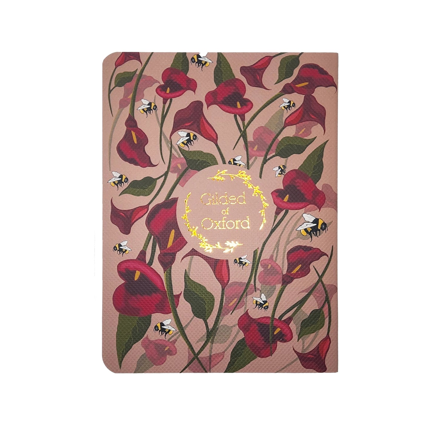 Notebook with floral design and 'Gilded of Oxford' text on a pink background