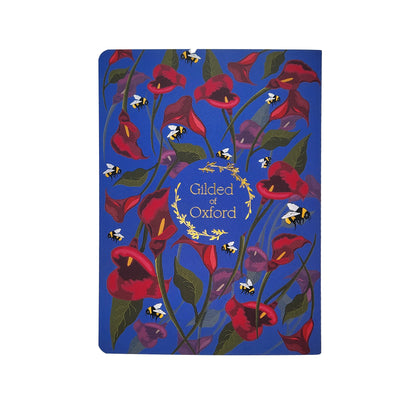 Floral soft cover notebook with 'Gilded of Oxford' gold foil branding on a indigo background