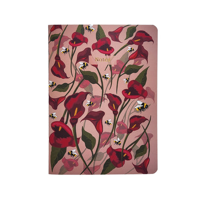 Notebook with red floral design and bee illustrations on a pink background