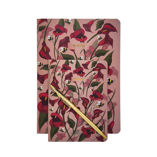 Floral soft cover journal with a pen on a white background